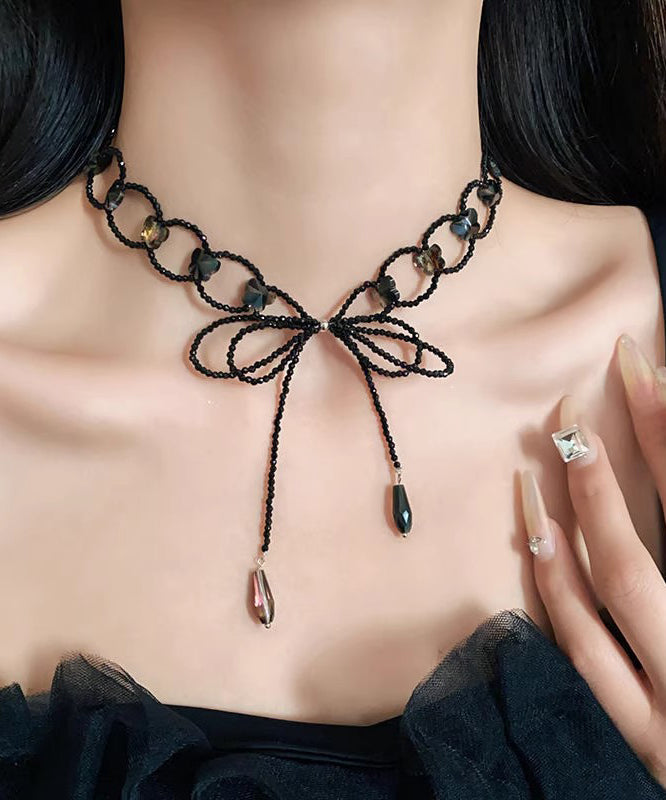 Collier sautoir ajouré à nœud papillon noir tissé - TrendAura