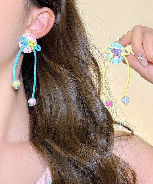 Boucles d'oreilles pendantes à pompon et nœud papillon arc-en-ciel faites à la main - TrendAura