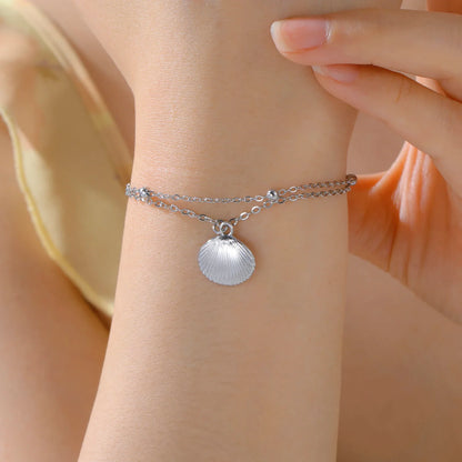 Elegant women's bracelet made of stainless steel with shell pendant in color