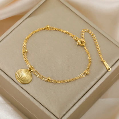 Elegant women's bracelet made of stainless steel with shell pendant in color