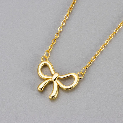 Women's copper necklace with cutout bow design