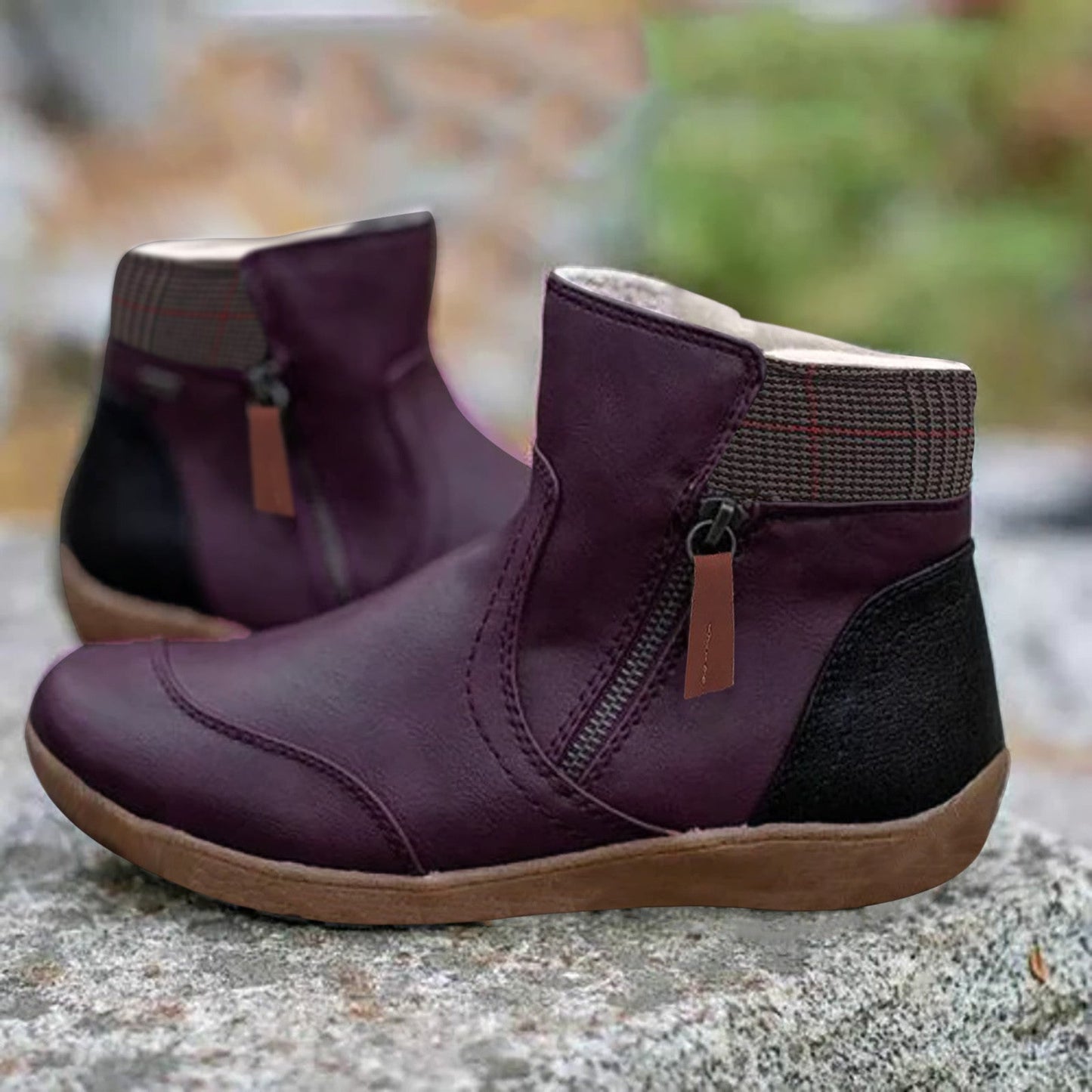 Black ankle boots with a zipper, insulation, and checkered detailing